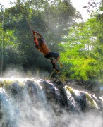 Rope Swinging into a waterfall Hawaii